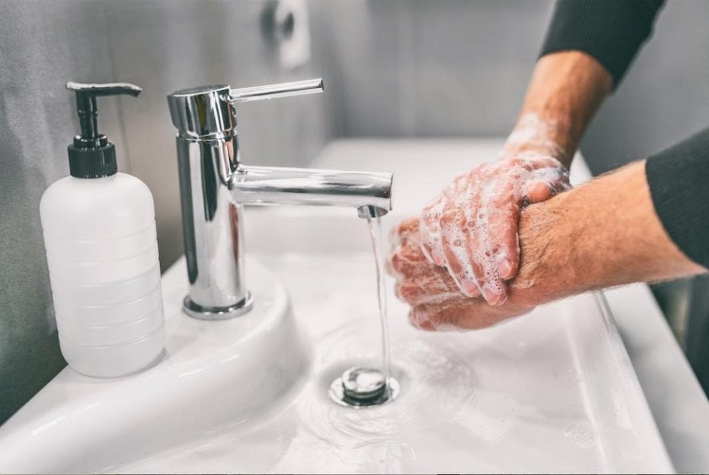 excessive hand washing and cleanliness can be a symptom of OCD a person washing hands with soap