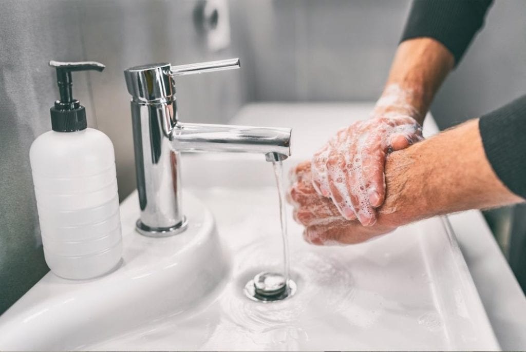a person washing hands with soap