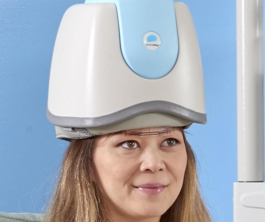 Patient wearing a BrainsWay depression TMS helmet