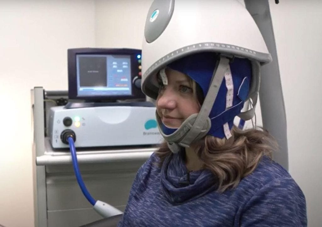 Women with Deep TMS helmet