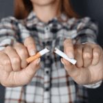 Women breaking a cigarette