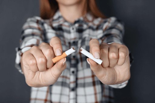 Women breaking a cigarette