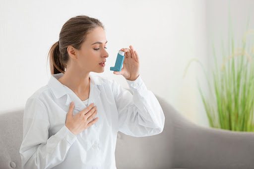 Woman with asthma inhaler