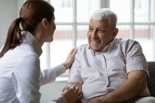 Women talking with old man