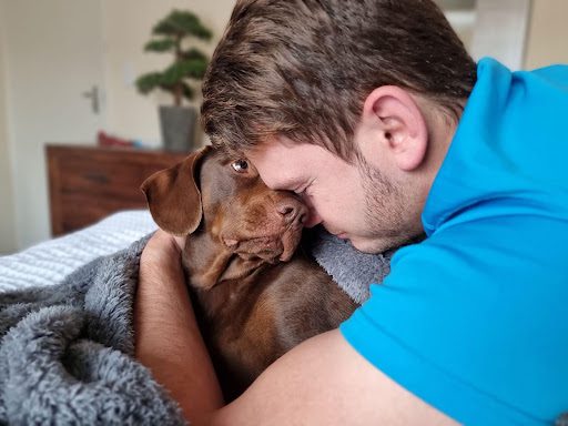 A man hugging a support dog