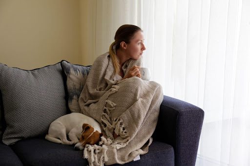Depressed woman sitting with a dog