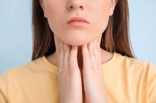 Woman touching her neck